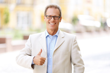 Pleasant man standing in the street 