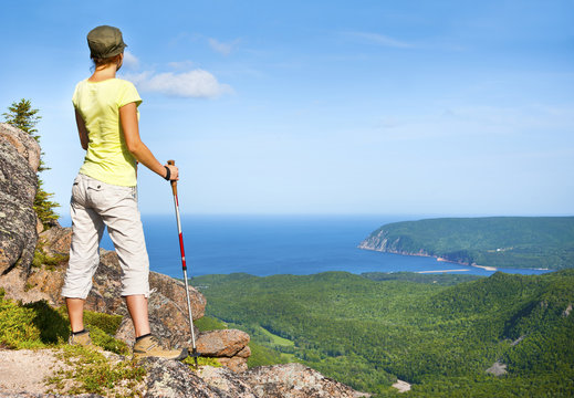 Hiker grasping views of Ingonish and Atlantic from Franey Mountain, Nova Scotia, Canada