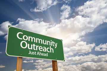 Community Outreach Green Road Sign Over Clouds