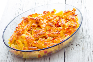 Baked macaroni cheese with tomatoes and sausage