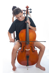 Smiling girl child practicing on her cello