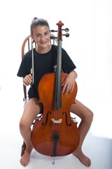 Girl child taking a break from cello practice.