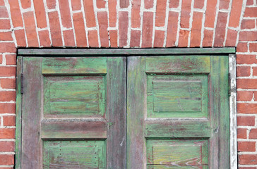 Two Green Doors in  a Red Brick Building