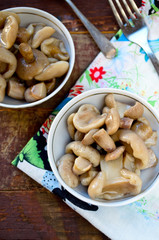 Pickled mushrooms with garlic in white bowl