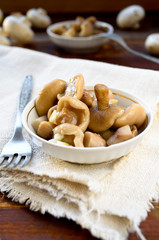 Pickled mushrooms with garlic in white bowl