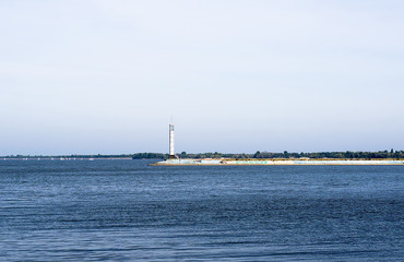 Contrast sea panorama with lighthouse on the pier