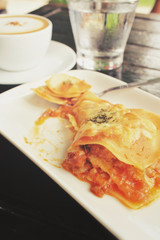 Italian lasagna with coffee cup