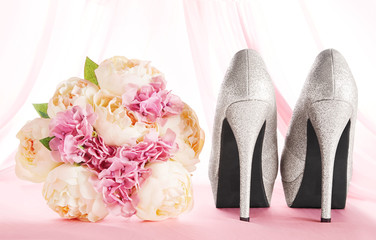 A bouquet and brilliant silver shoes. Wedding bridal fashion image. 