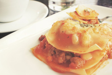 Italian lasagna with coffee cup