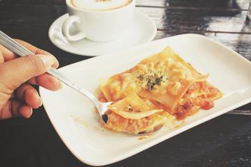 Italian lasagna with coffee cup