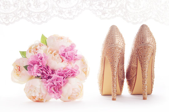 A bouquet and brilliant gold shoes. Wedding bridal fashion image. 