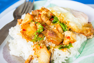 Spicy crispy pork puff with basil and fried egg.