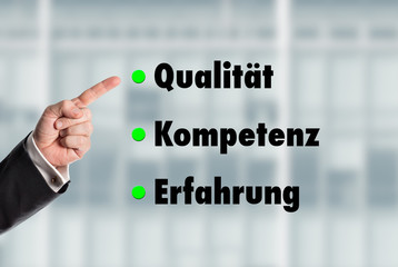 Business man pointing at the words, Quality-Competence-Experienc