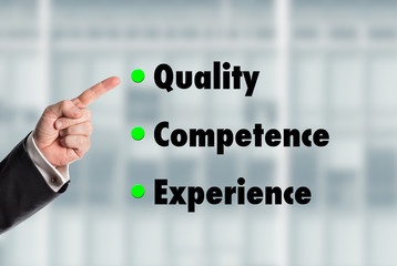 Business man pointing at the words, Quality-Competence-Experienc