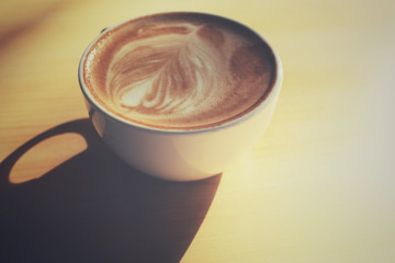 Vintage latte art coffee with shadow