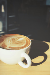 Vintage latte art coffee with shadow