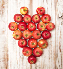 Apples heart over wooden background. Love concept vibrant