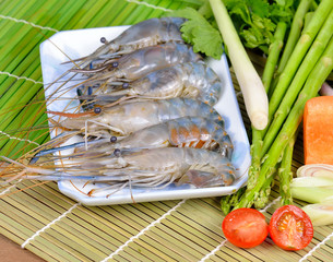 Delicious fresh shrimps and vegetables on wooden background