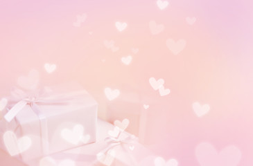 Pastel pink background, with gift boxes