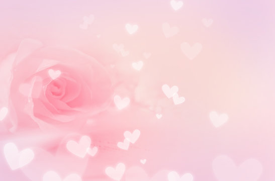 Pastel pink background, with rose and hearts
