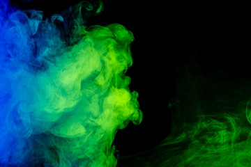 Abstract blue and green smoke hookah on a black background.