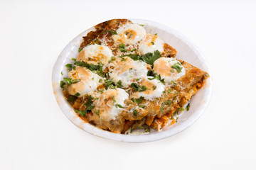an indian dish Tandoori Omlette in which bread is rolled between an omlette and slightly baked then topped with mayonnaise and cheese isolated on white background available with clipping mask