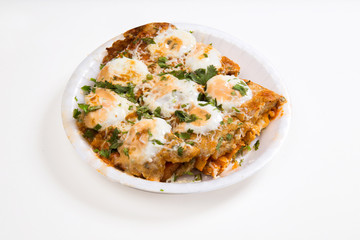 an indian dish Tandoori Omlette in which bread is rolled between an omlette and slightly baked then topped with mayonnaise and cheese isolated on white background available with clipping mask