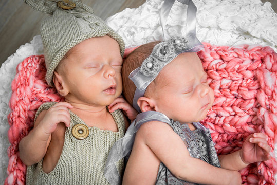 newborn twins l sleeping in a basket