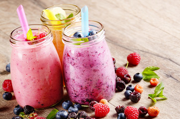 Assorted fruit shakes on white table