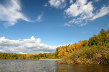 Landscape colorful autumn forest lake river sky clouds