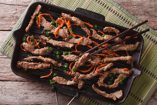 Korean bulgogi beef with carrot on grill pan. horizontal top view
