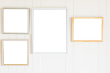 Blank photo frame on white wood wall background
