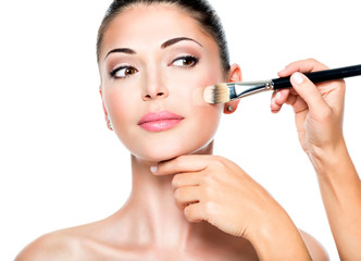 Fototapeta premium Makeup artist applying liquid tonal foundation on the face