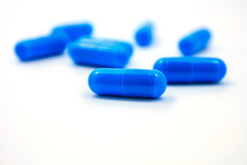 blue capsules on a white background