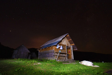 Beautiful landscape with a house in the mountains against the sk