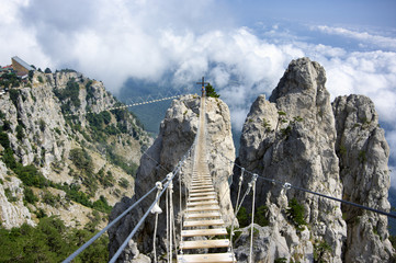 Fototapeta na wymiar Hanging bridge in mountains