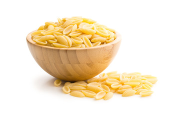 uncooked italian pasta in wooden bowl