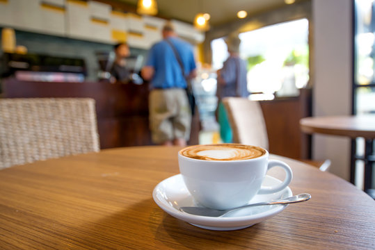 Cup of coffee on table in cafe - selective focus point, shallow depth of field