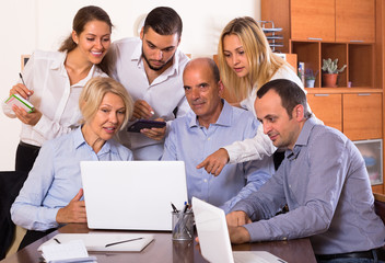Fototapeta premium Colleagues looking at laptop.