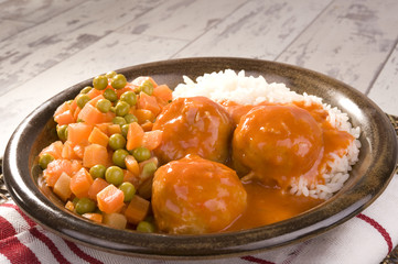 white rice, peas and carrots and delicious meatballs in tomato sauce 