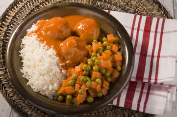white rice, peas and carrots and delicious meatballs in tomato sauce 