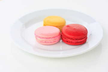 Sweet and colourful french macarons on white table
