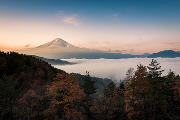 Mount Fuji enshrouded in clouds with clear sky from lake kawaguchi, Yamanashi, Japan