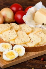 Buttered bread with slices of aromatic cheese and pepper