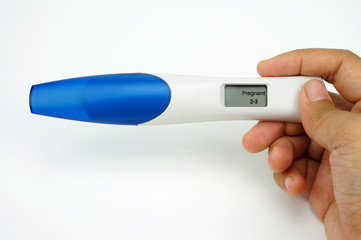 Holding digital pregnancy test isolated on white background. The