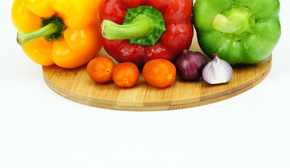 Close up of colorful peppers with cherry tomatoes and onion over