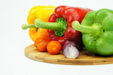 Close up image of colorful peppers with cherry tomatoes and onio