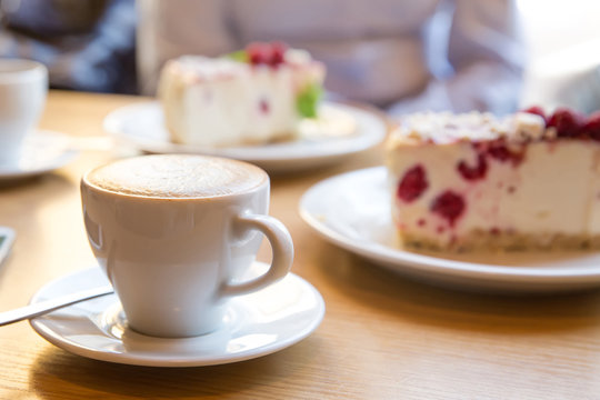 coffee and cheesecake with raspberries