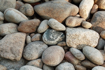 Fototapeta na wymiar Grey pebbles on the beach