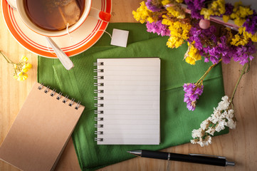 Notepad with pen on wood table
